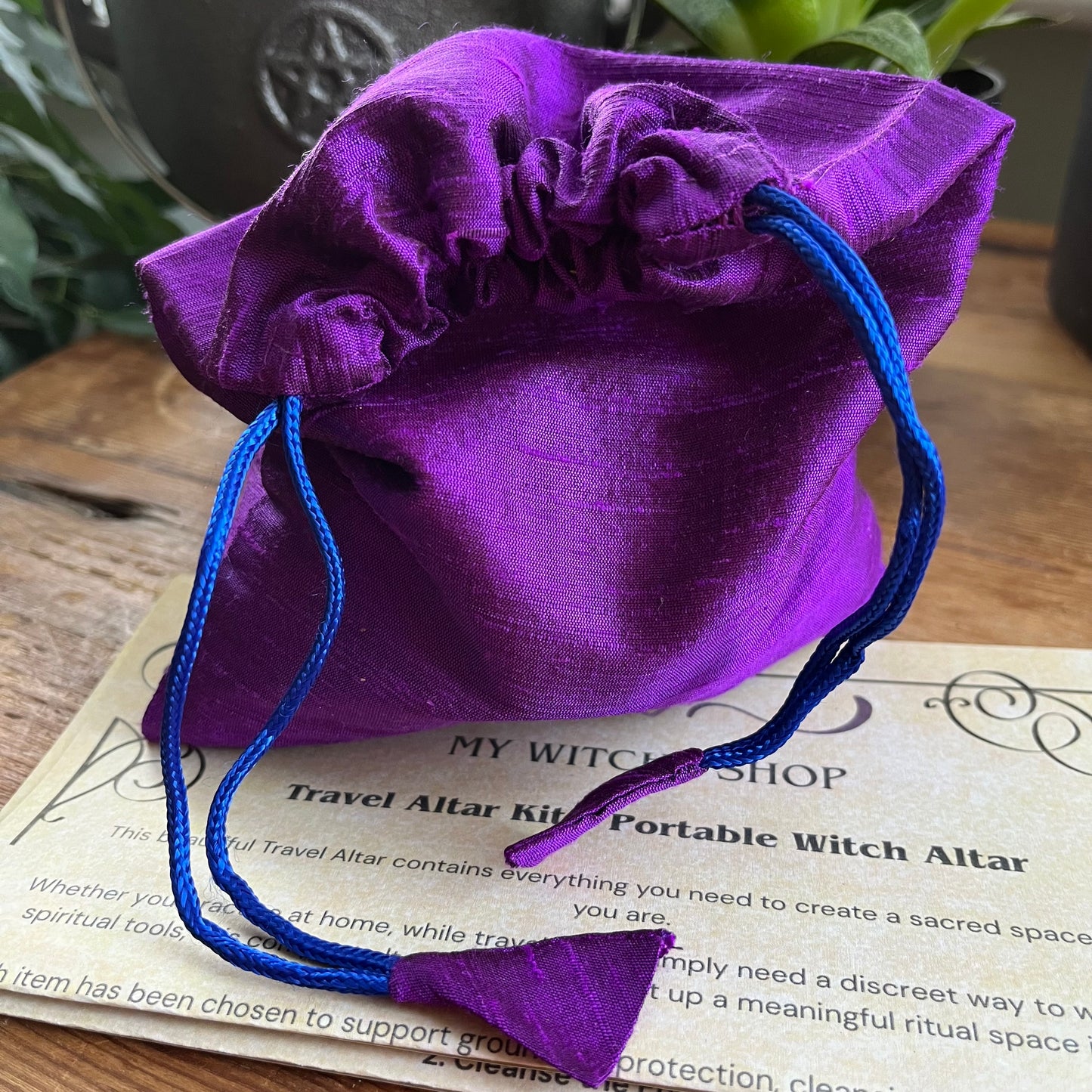Purple drawstring bag on a piece of paper with text