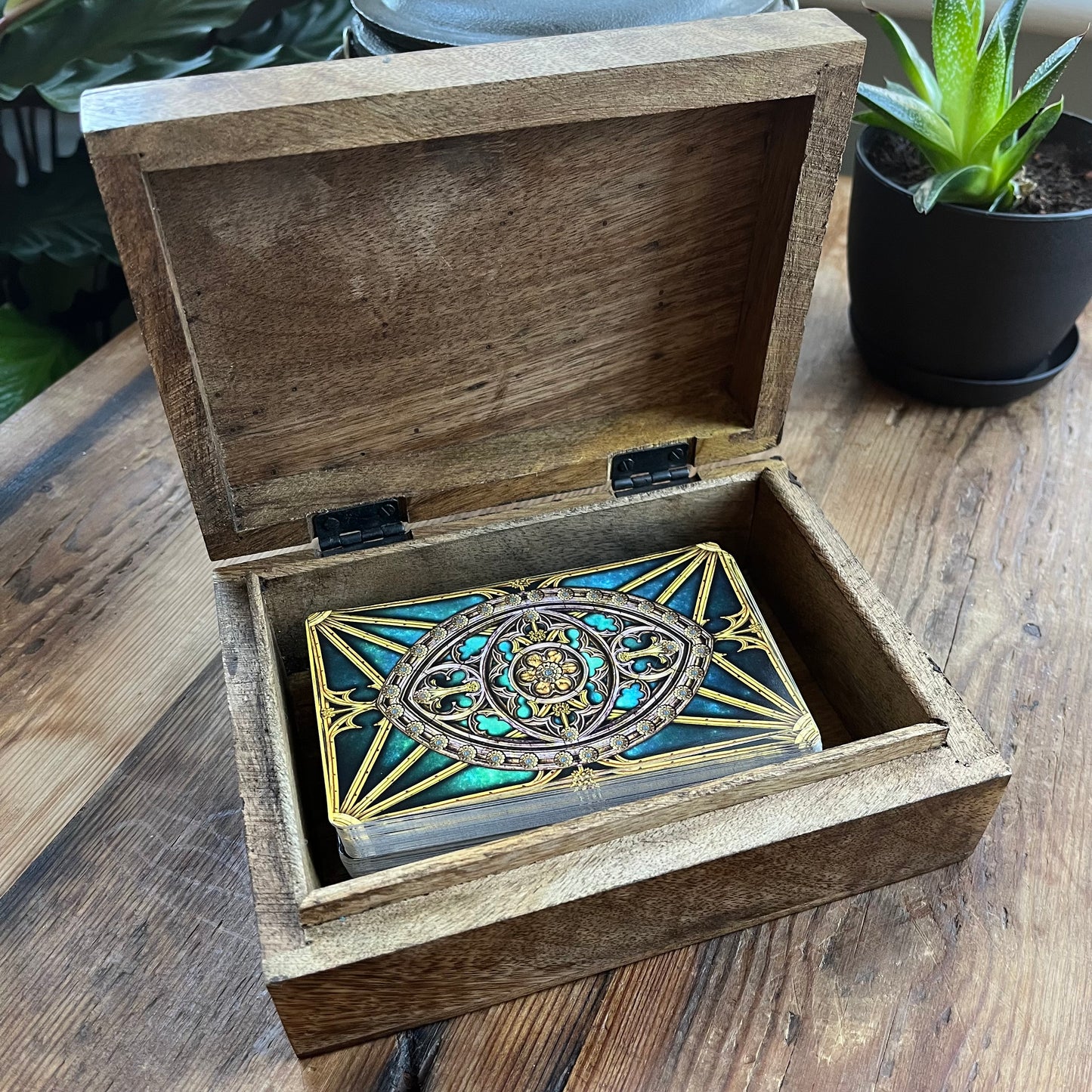 Wooden box with decorative Tarot Cards on wooden surface