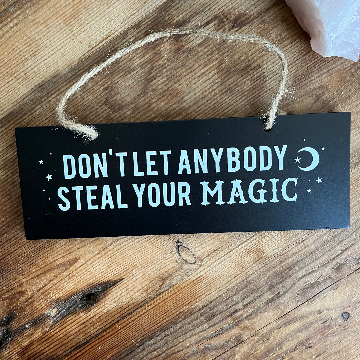 Black MDF wall sign with the wordsWall sign don't let anybody steal your magic  in white 