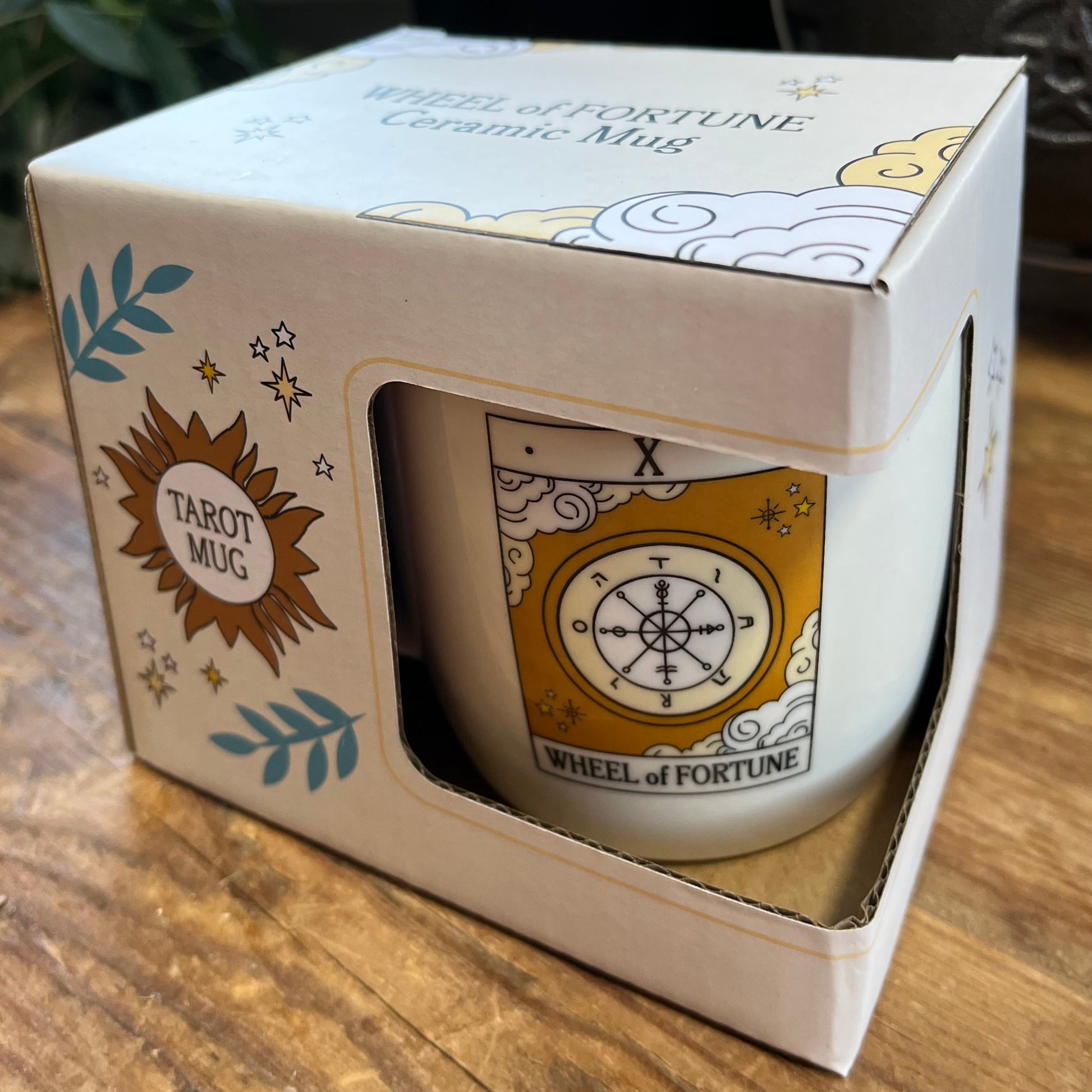 Ceramic mug with 'Wheel of Fortune' design in a box labeled 'Tarot Mug'.