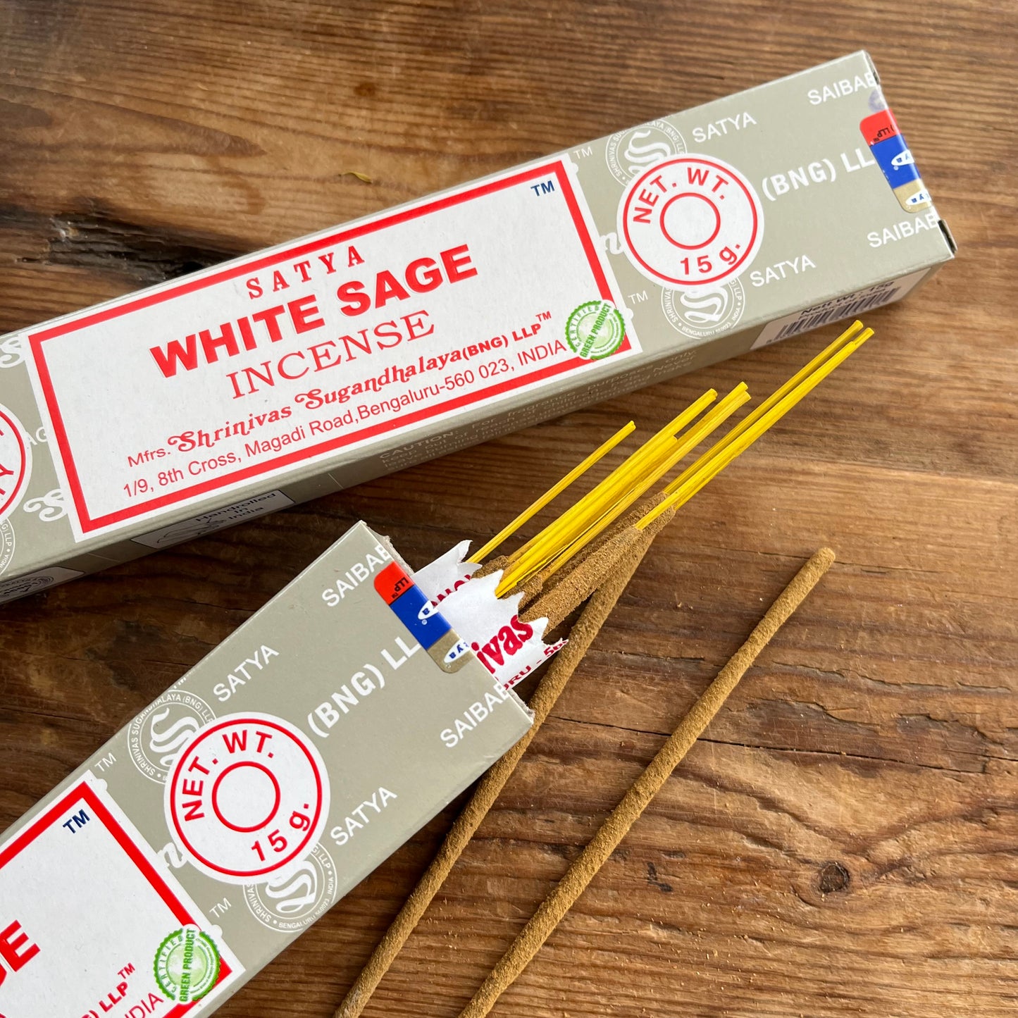 2 Boxes of Satya White Sage incense on a wooden surface one open  and one sealed