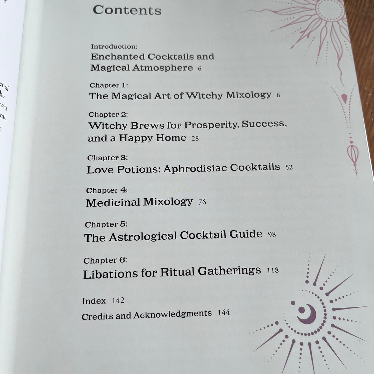 A printed book or booklet page showing the Contents section with chapter titles and page numbers, photographed close up on a wooden surface.