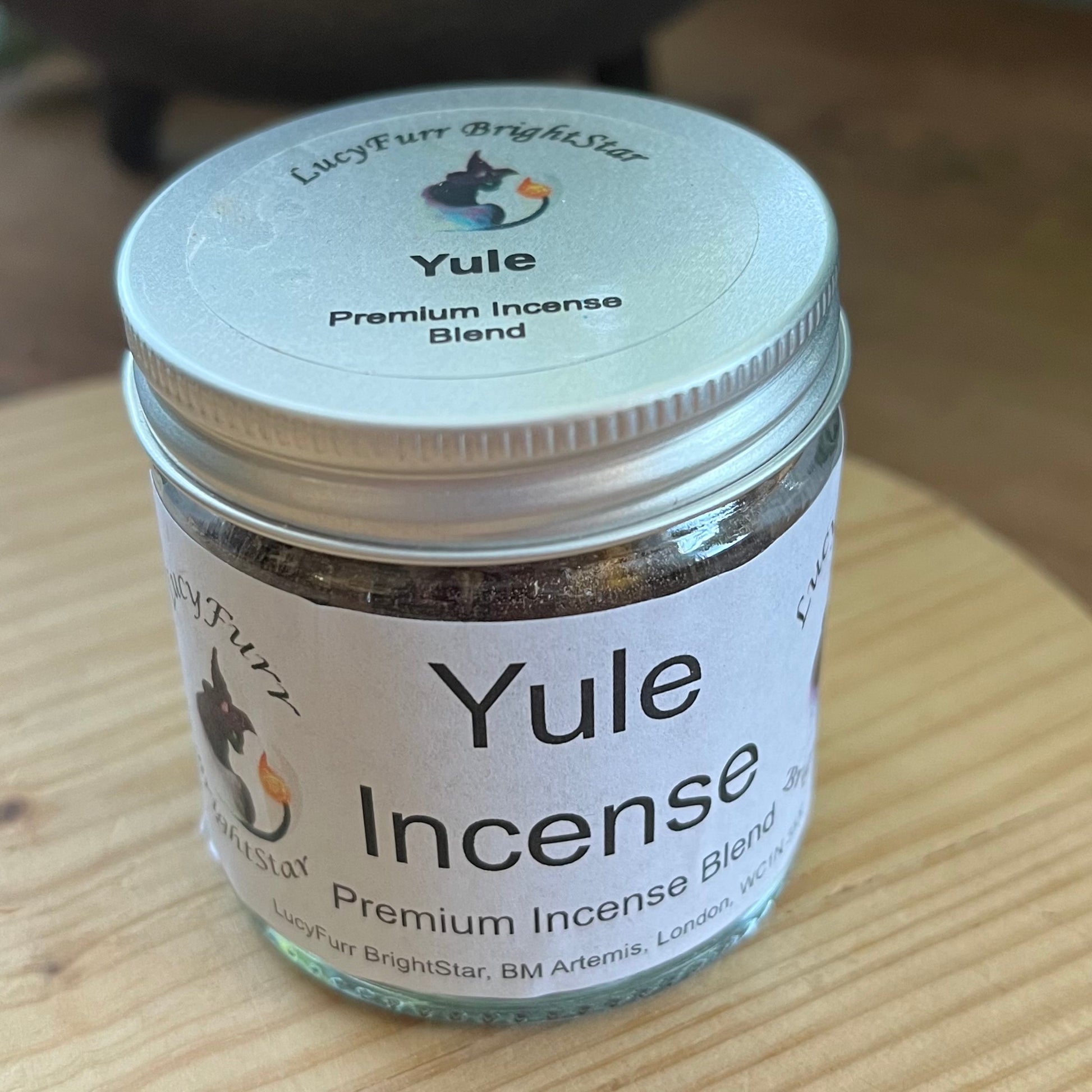 Jar of Yule Incense Blend on a wooden surface