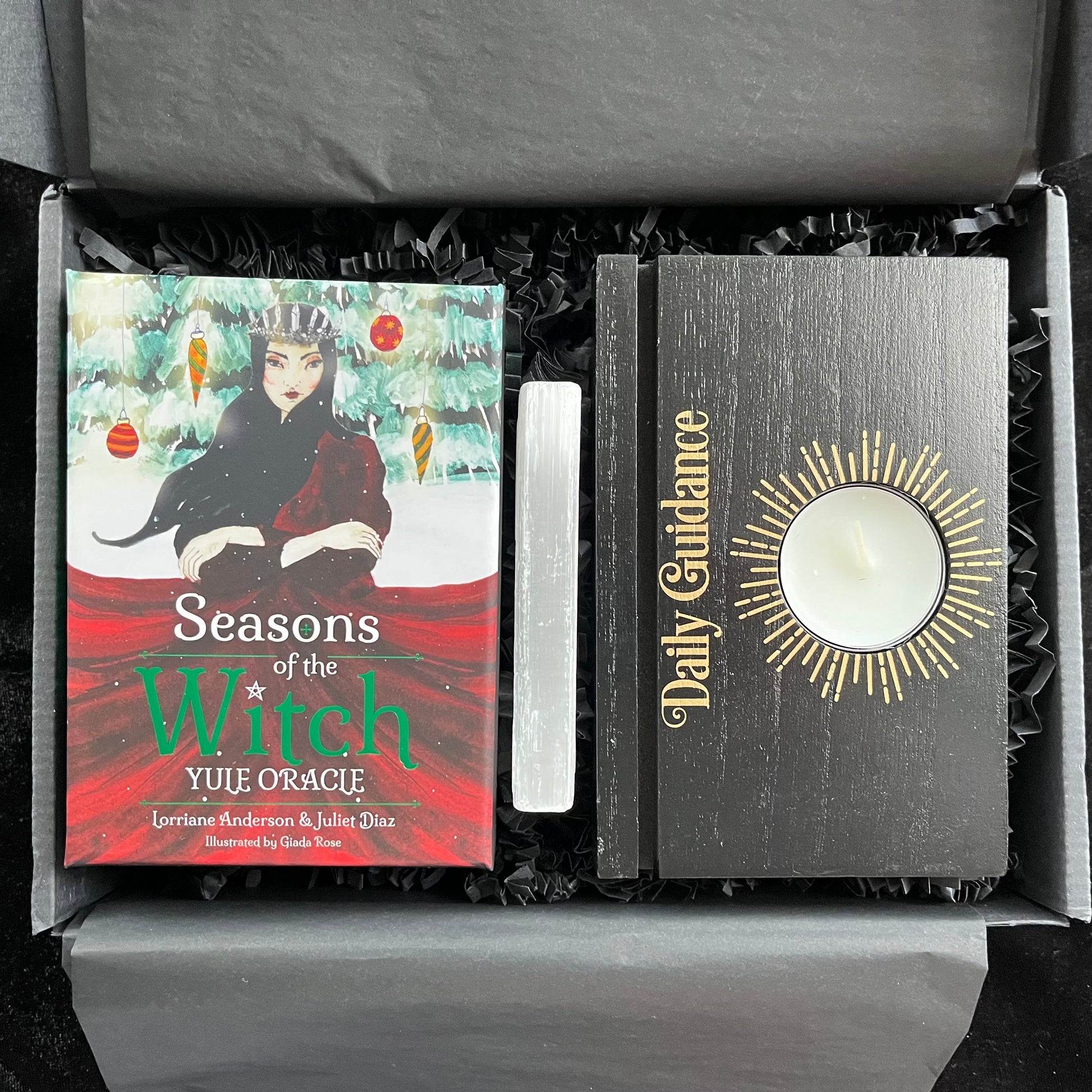 Oracle deck titled 'Seasons of the Witch' and 'Daily Guidance' Tarot stand with a Selenite stick in an open gift box.