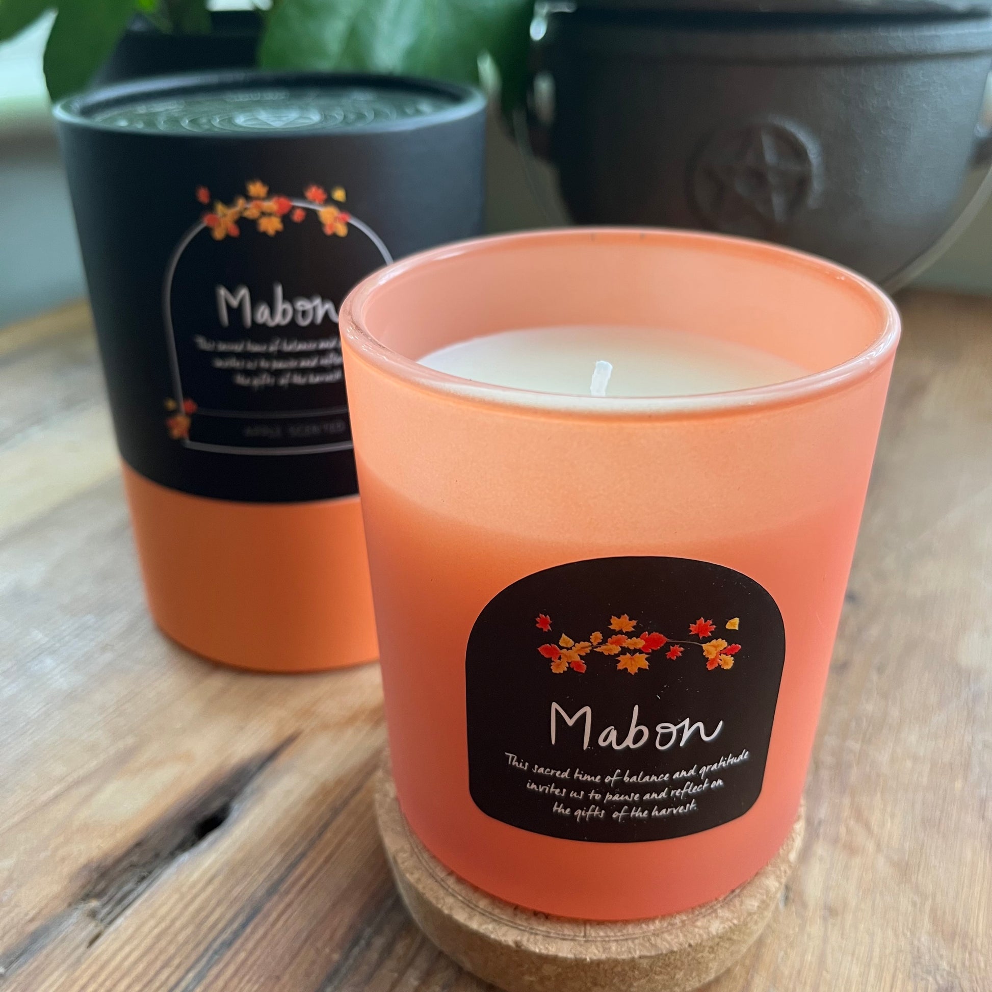 Candle with 'Mabon' label on a wooden surface