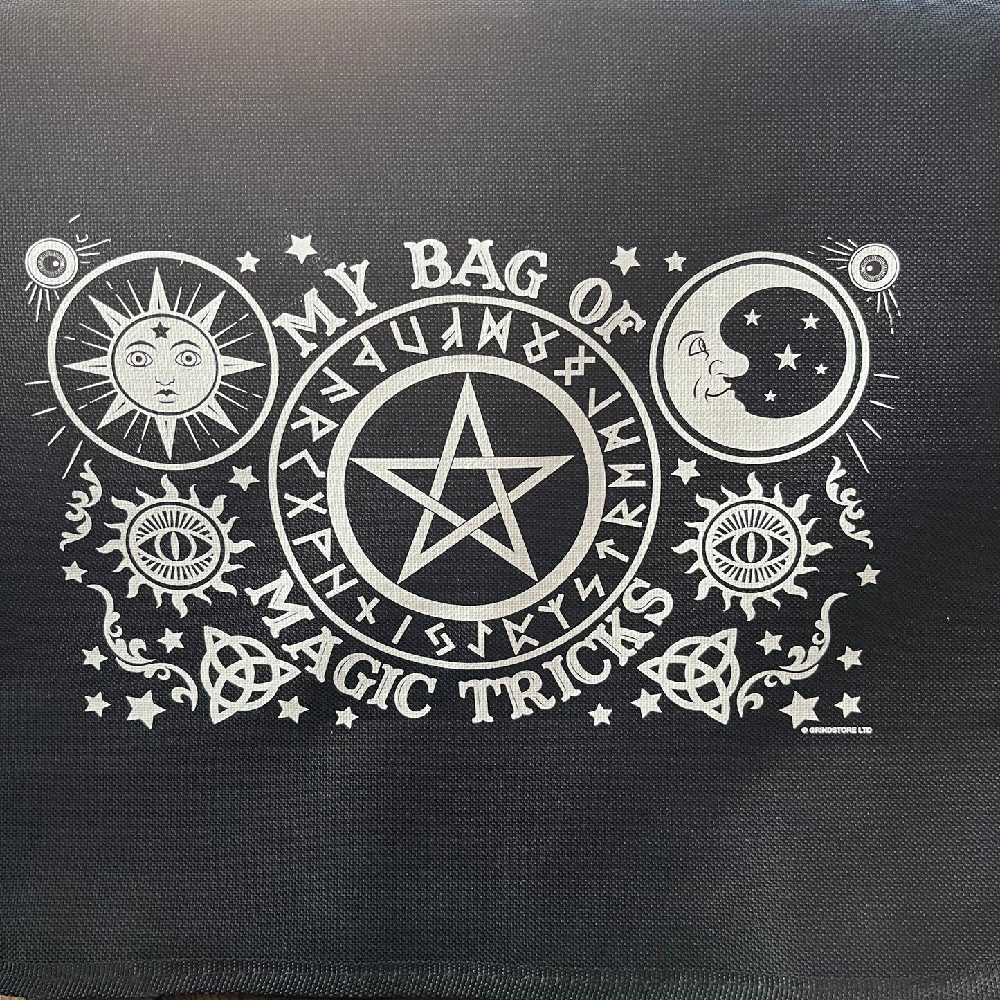 Black bag with white pentacle design and text on a black background
