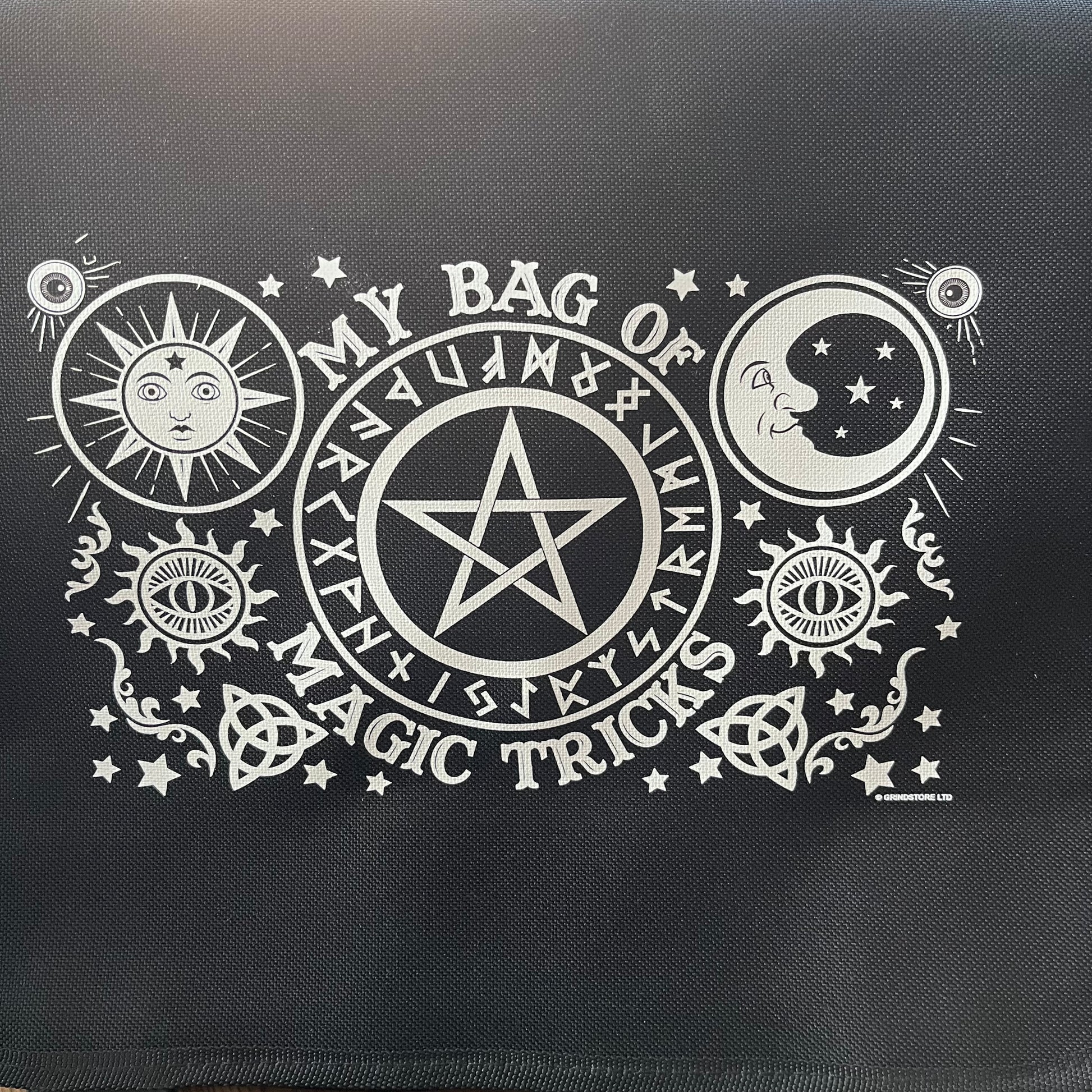 Black bag with white pentacle design and text on a black background