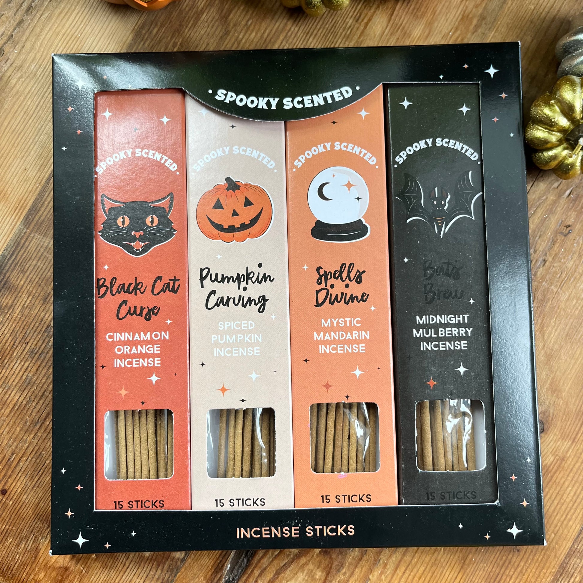 Spooky scented incense sticks set in a black box on a wooden surface