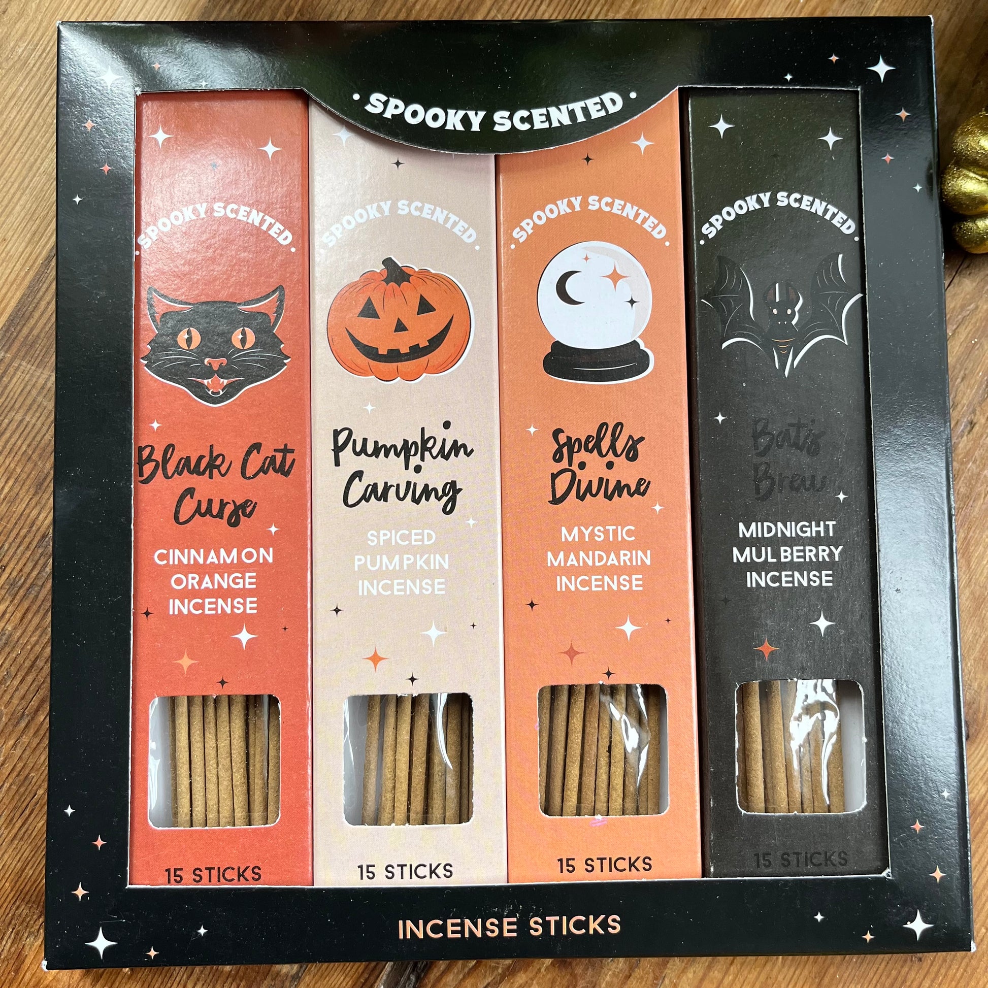 Spooky scented incense sticks set in a black box on a wooden surface