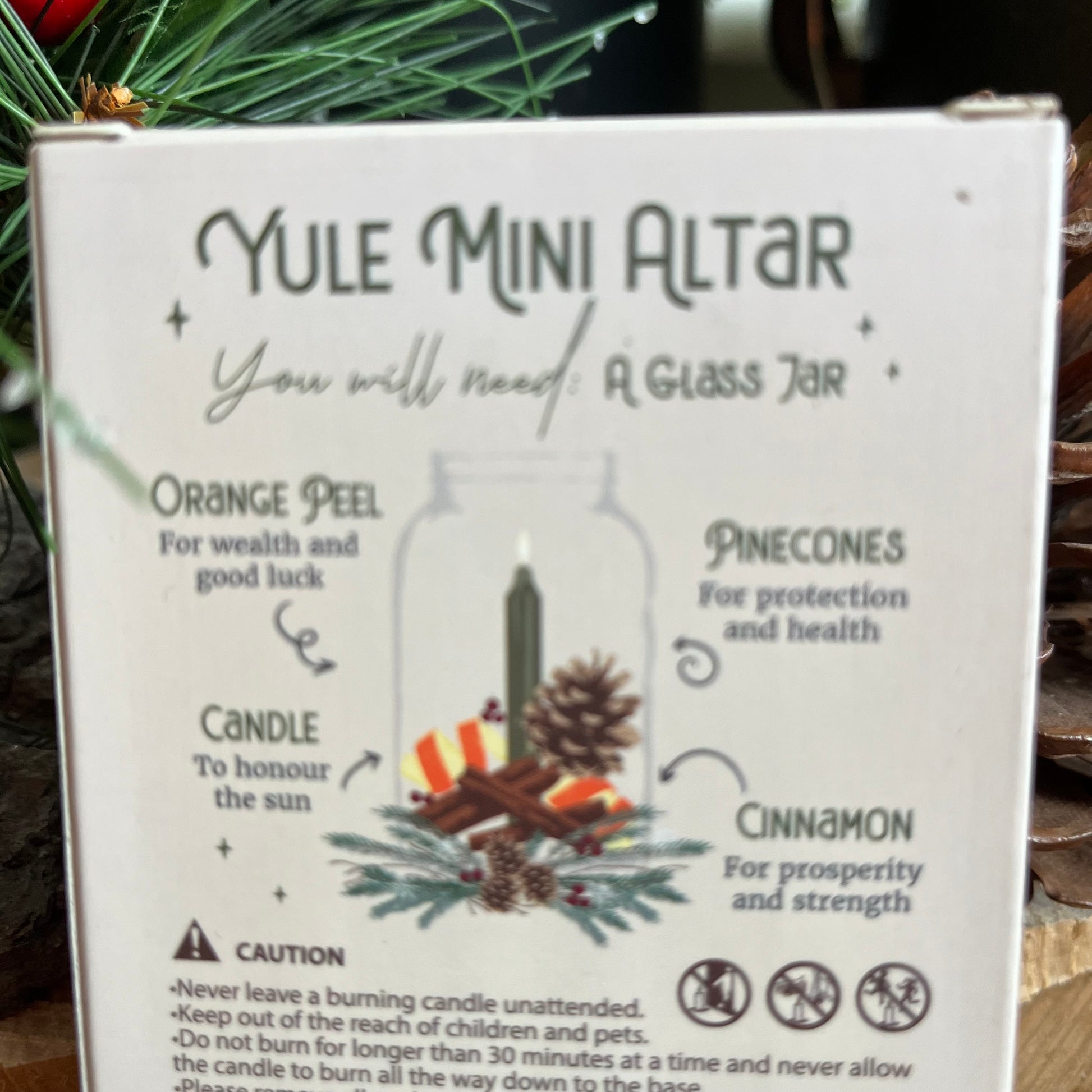Back of the winter rital candles, shown instructions for creating a mini yule altar in a glass jar 